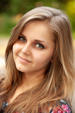 Portrait of a young beautiful girl in the park