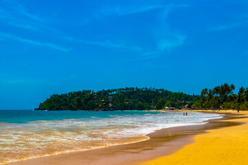 Beautiful paradise tropical beach waves palms Mirissa Beach Sri Lanka.