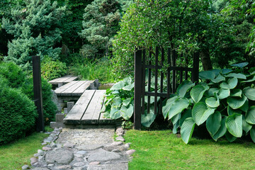 traditional zigzag bridge behind the whisket, gate in the Japanese garden