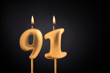 Birthday candle number 91 - Birthday celebration on black background