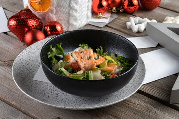 Salmon steak, calamari, shrimp with salad for New Year's table. New Year's decoration, beautiful table. Side view, macro