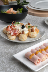 Stuffed ham rolls garnished with Dijon mustard. Plate on the festive table.