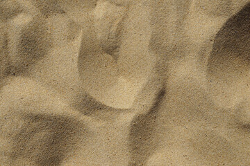 sand texture background with natural ripple shapes. sandy beach surface 