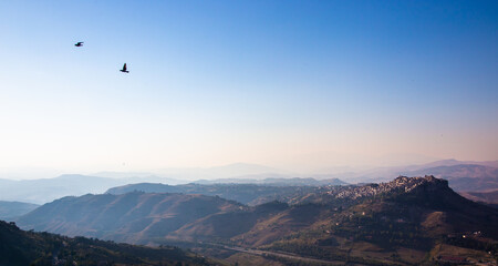 Scenic view from the hilltop town of Enna, overlooking the town of Calascibetta and the surrounding areas. 