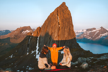 Family mother and father with child traveling together in Norway camping in mountains adventure vacations healthy lifestyle parents playing with kid Segla peak view eco tourism outdoor - obrazy, fototapety, plakaty