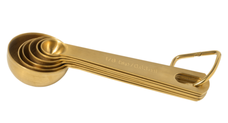 Golden metal measuring spoons for bulk and liquid products on a white isolated background