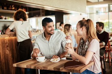 Young mixed couple enjoying a cup of coffee in a cafe