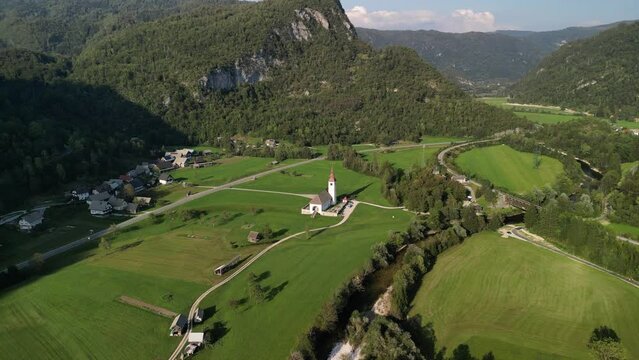 Aerial View Church in the countryside with Highway run pass by at Bohinjska Bistrica, Slovenia  