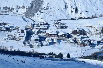 View of snowy Obergurgl Austrian ski resort from above. Aerial view of the snowy alpine village,...