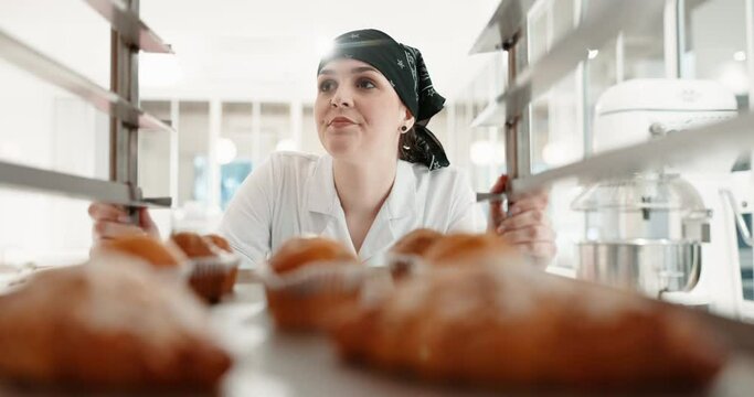Restaurant, pastry chef and woman in commercial kitchen for baking job. Professional baker person walking with food trolley for catering or bakery industry production, breakfast croissant or service