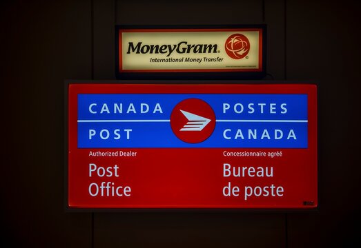 CANADA POST and MoneyGram banner at Post Office Outlet in English and French. Canada Post office locations are present at 6,000 post across Canada.  Halifax, Nova Scotia, Canada - 31 AUG 2023
