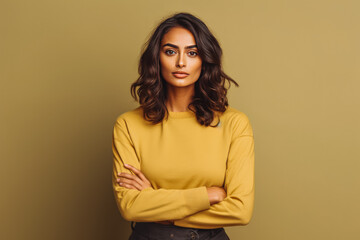 Obraz premium Portrait of beautiful latino female looking serious in casual clothes on a colored background