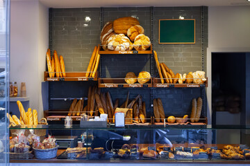 Bakery shop with assortment of bread on shelves. High quality photo