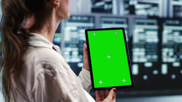 Octogenarian specialist in servers workspace housing high end processors capable of quickly and efficiently performing complex computations and data analysis, using mockup tablet to recondition rigs