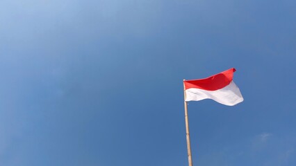 Indonesian flag. Red and white flag. In blue sky