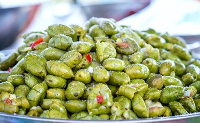 Sweet and sour pickled toad fruit is sold at the market, a popular street food in Vietnam