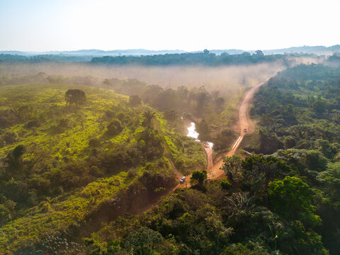 Drone shot of the famous earth road Transamazonica towards Santarém in dry season through the Amazon rainforest in northern Brazil, South America in the morning sun