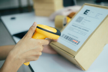 Scanning parcel barcode before shipment..