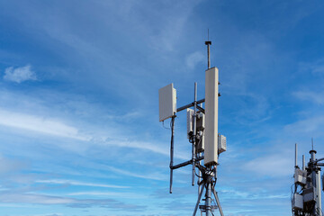 Small Cell 3G, 4G, 5G System. Macro Base Station or Base Transceiver Station on Electricity post. Wireless Communication Antenna Transmitter. Development of communication system in urban area.