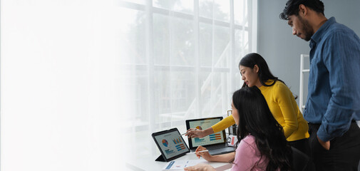 Team of confident Asian businessmen working together in the office technology creative team brainstorming meeting calculate income graph document Internet partner. copy space, banner, panorama