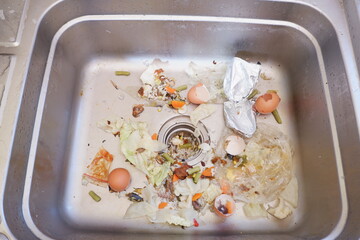 the sink is clogged with food residue. food waste can be used as natural compost