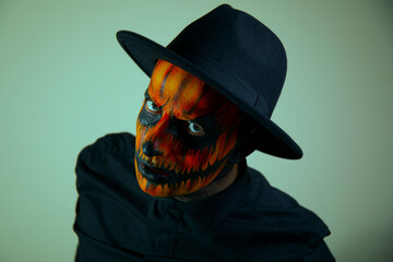 Handsome Halloween man with pumpkin