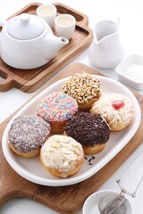 donuts of various shapes with colorful toppings with a variety of sweet and savory flavors