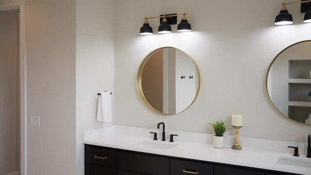 Medium tight shot of a white bathroom sink with black faucet, white countertops, and circular mirror