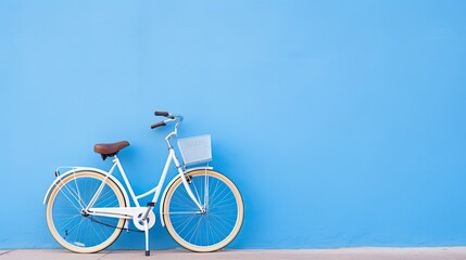 Fototapeta premium Bicycle on blue wall with copy space for your text or design