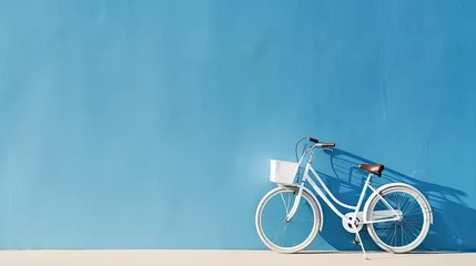 Fotobehang Fiets Bicycle on blue wall with copy space for your text or design