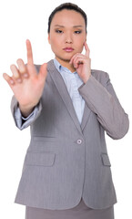 Digital png photo of asian businesswoman touching virtual screen on transparent background