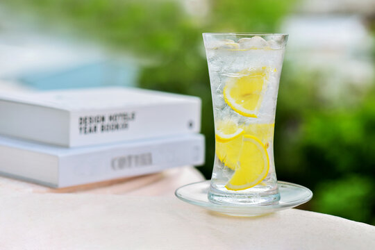 iced lemon juce with a pices of lemons slice  with book background. this is a thirst-quenching drink, refreshing drink, sweet, sour and aroma beverage to enjoy during the lingering summer heat.