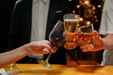 food and drink male friends are happy drinking beer and clinking glasses at a bar or pub.