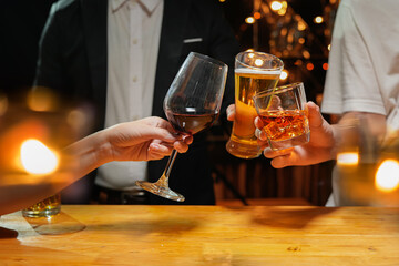 food and drink male friends are happy drinking beer and clinking glasses at a bar or pub.