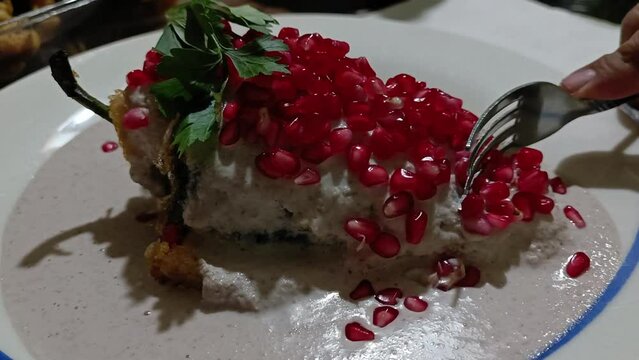 Chiles en nogada, a Mexican dish made with a stuffed poblano pepper, walnut and pomegranate