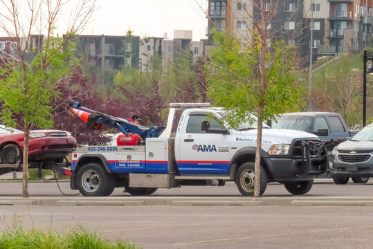 Calgary, Alberta, Canada. Sep 1, 2023. An CAA AMA Roadside Assistance truck towing a broken car.