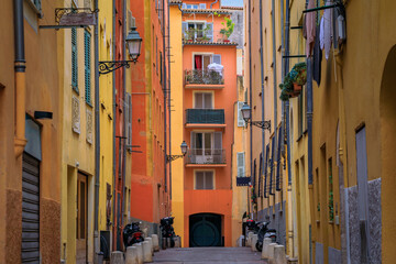 Fototapeta na wymiar Picturesque colorful traditional old houses on a street in the Old Town, Vieille Ville in Nice, French Riviera, South of France