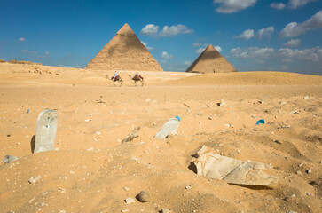 Environmental pollution at Giza pyramid complex in Egypt, Weathered old plastic bottles laying in...