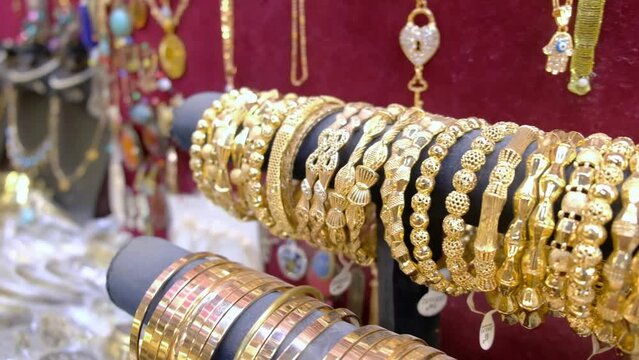 Row of golden jewelry bracelets at traditional middle eastern bazaar
