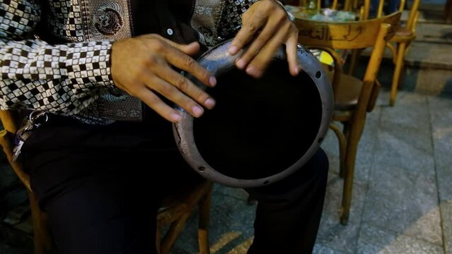 Hands of man playing darbuka. Man plays egyptian tabla drum. Chalice drum hand percussion
