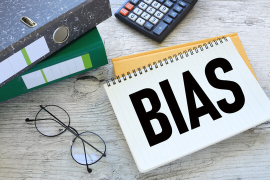 Bias open notepad with text on yellow notepad. two folders for documents
