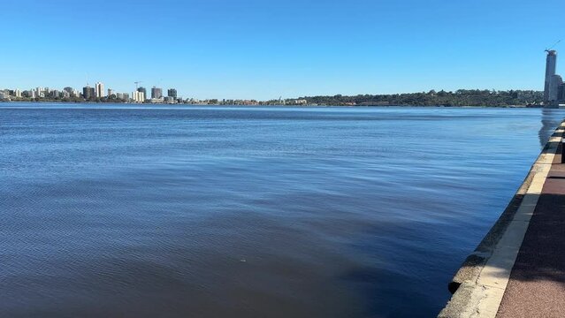 Looking down the footpath of Riverside Drive across the Swan River to Elizabeth Quay, Kings Park and South Perth foreshore.