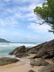 Fototapeta na wymiar Tropical beach with granite cliffs and blue skies. Thailand.