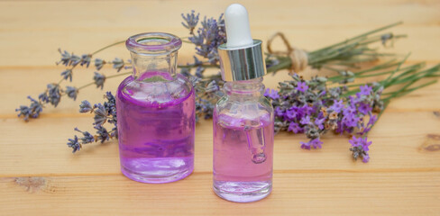 Obraz na płótnie Canvas lavender essential oil, on a wooden background. Selective focus
