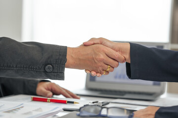 Shaking hands, Asian senior man and woman collaborating in small medium enterprises working together.