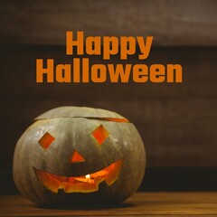 Composite of happy halloween text and halloween pumpkin on brown background