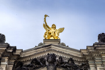 Fototapeta na wymiar The golden sculpture of Cupido on the roof of the art academy in Dresden