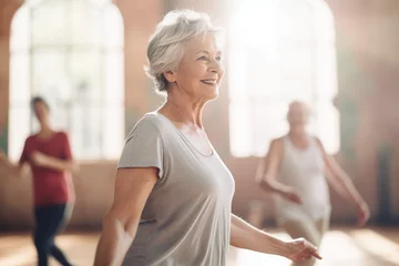Rollo Old woman with white t-shirt is happy in an indoor dance fitness class with retired friends, having fun enjoying, and celebrating, sunlight from the window © IgnacioJulian
