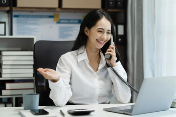 Obraz premium Business women talk mobile phones and working on laptop computers, online business, work from home, teleworking concept.