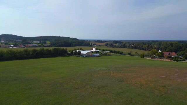Perfect aerial top view flight
II-62 airplane on ground. hilly summer fields Brandenburg Germany summer 23. fly reverse drone
High quality 4k cinematic footage